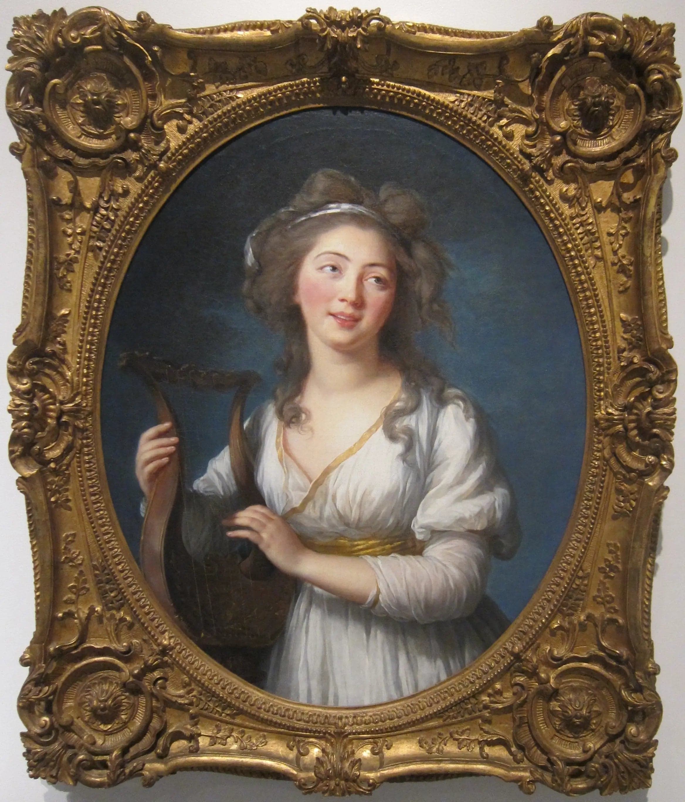 Portrait of a young woman playing the lyre