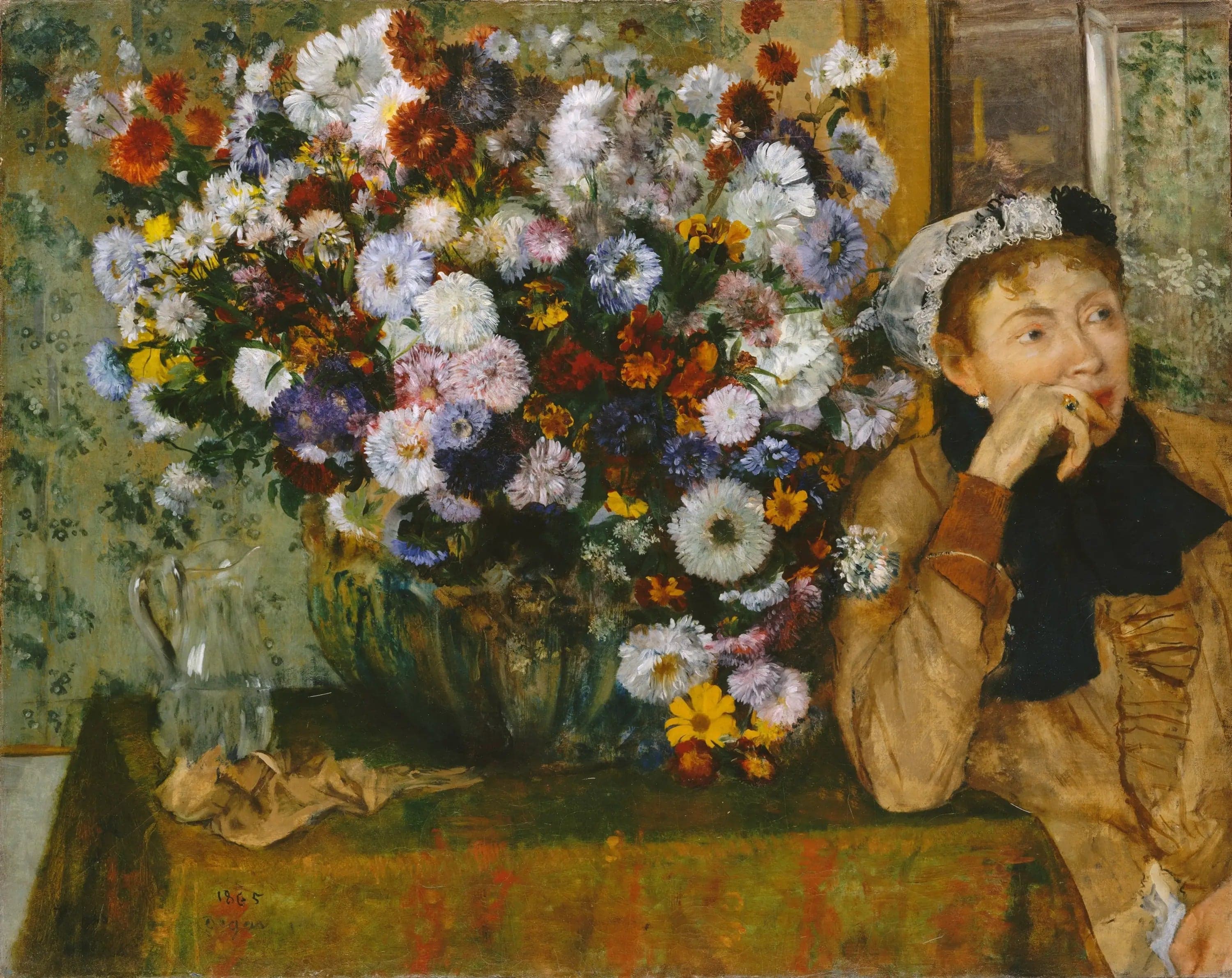 Woman Sitting Next to a Vase of Flowers