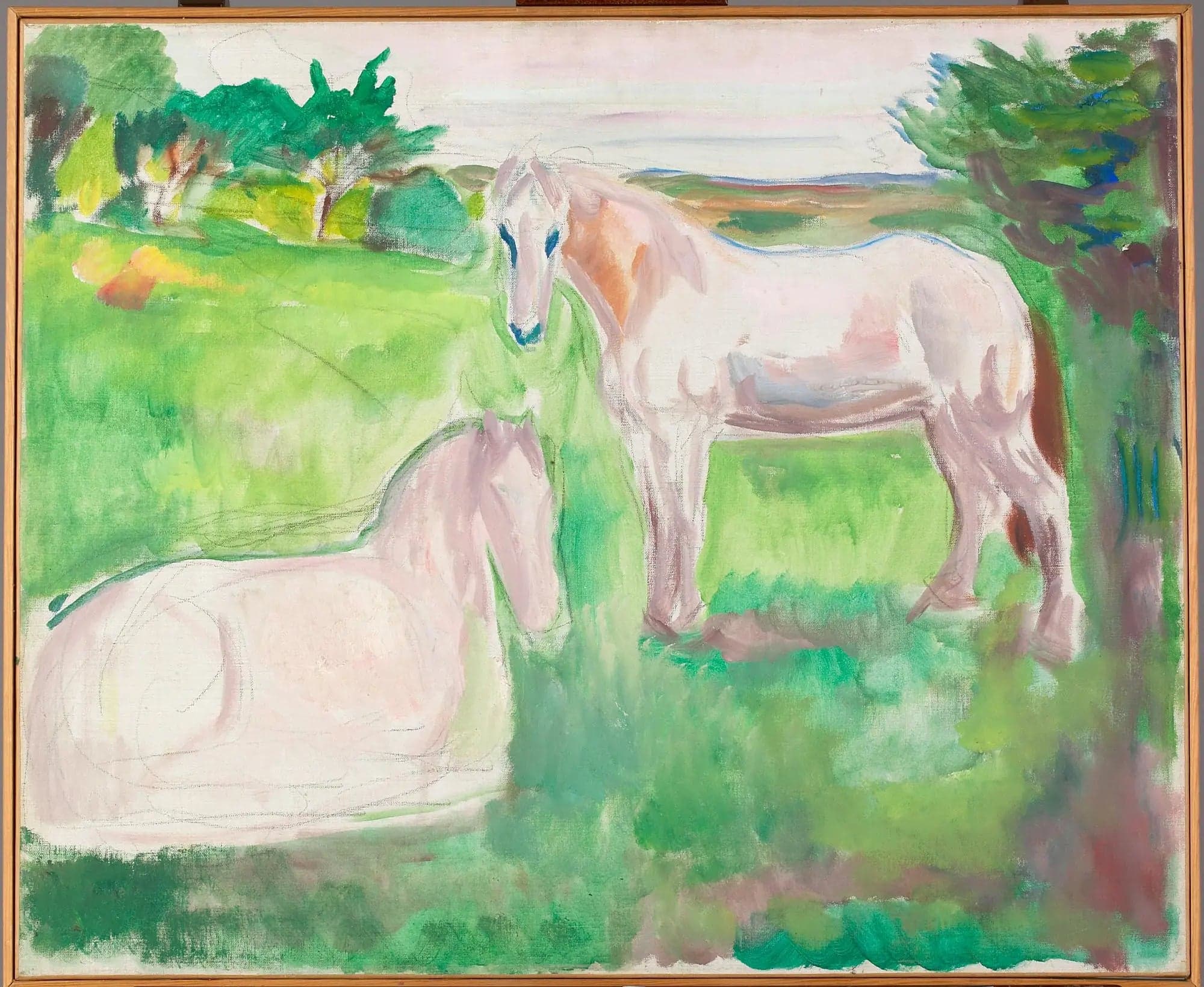 Two white horses in a green meadow