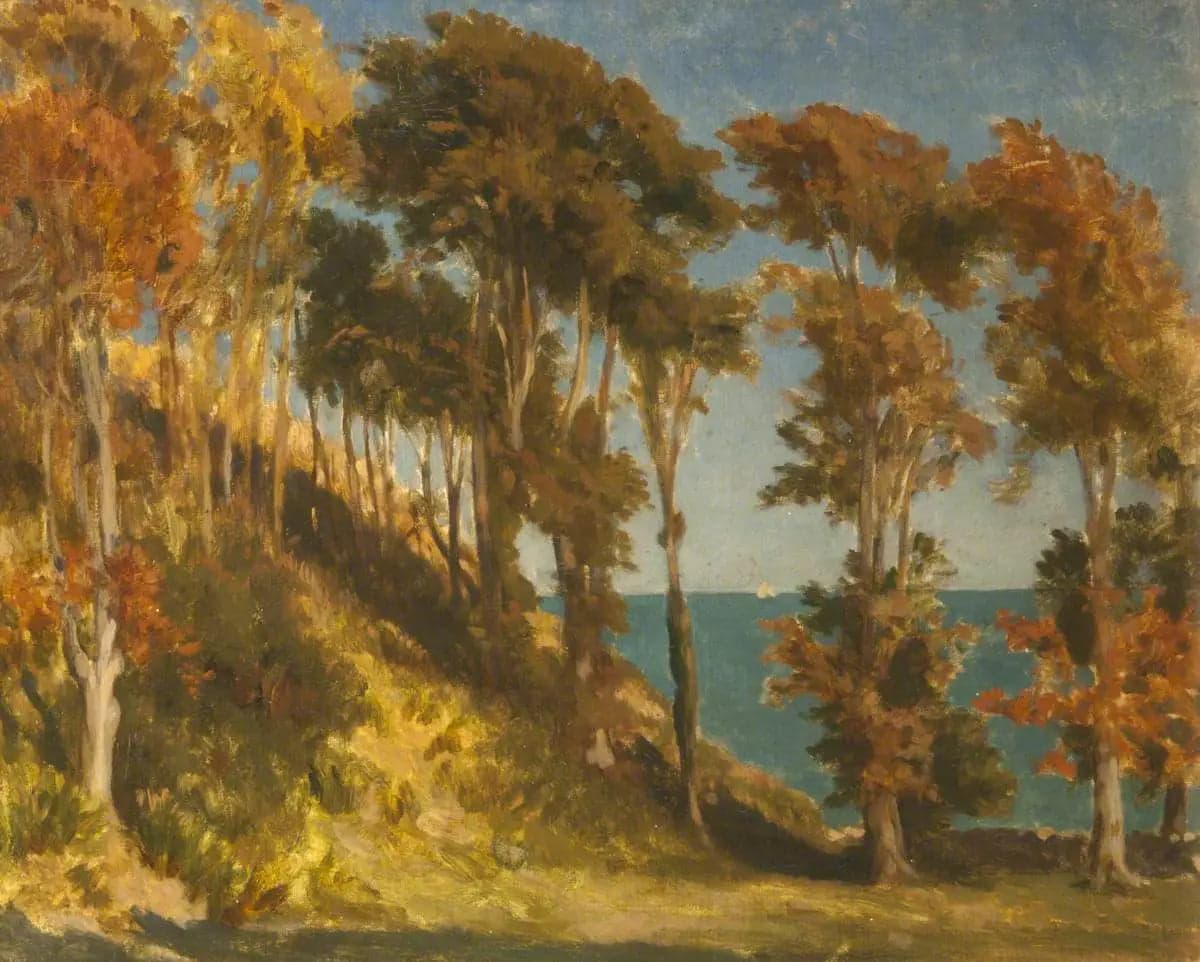 A wooded hill with the sea beyond