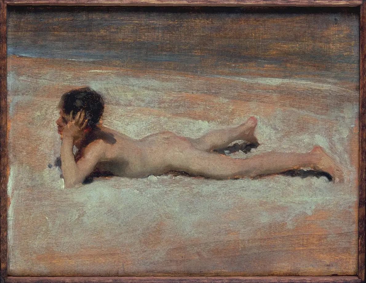 A naked boy on a beach
