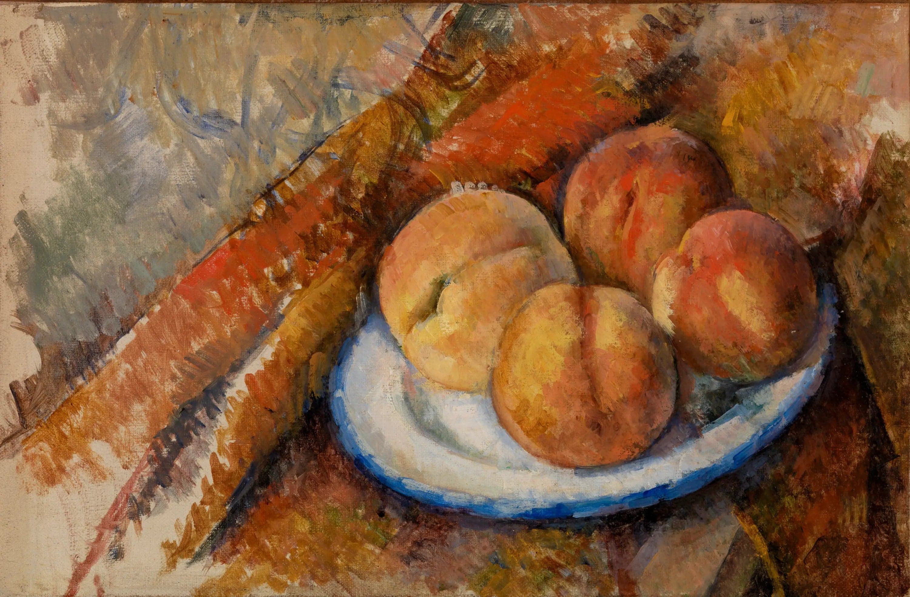 Four peaches on a plate